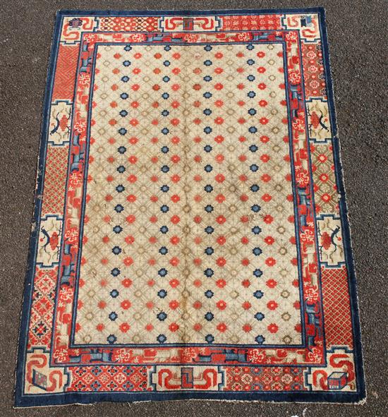 A small Chinese Suiyvan carpet, the fawn ground field woven with a lattice pattern, each cross centred by flowerheads, within a border